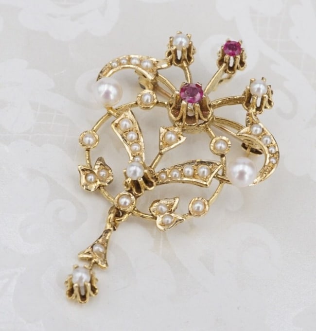 Antique Seed Pearl Ruby Pendant Brooch 14k Yellow Gold Abstract 1.7" PG1927: This incredible antique pendant features scrolls adorned with seed pearls around set two natural rubies. An additional pearl accent hangs below, giving this piece elegant movement. A perfect addition 