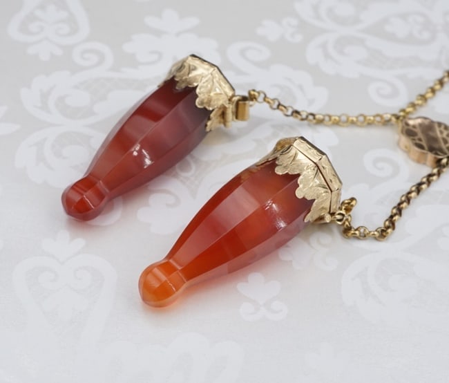 Antique 14K Gold Carved Carnelian Knitting Needle Guard Caps Necklace 19" M1780: This unique piece of history features a pair of hand carved carnelian knitting needle covers, capped in solid 14k yellow gold. They attach to a sliding chain for ease of use and added versatility. Met