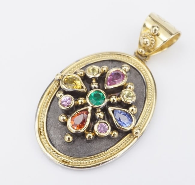 18k Yellow Gold Dovris Greek Old World Emerald Sapphire Pendant PG1801: This beautiful vintage piece features a floral burst created with brilliant colored sapphire, tourmaline and emerald against a dark enamel background. The details of this Etruscan inspired piece give 