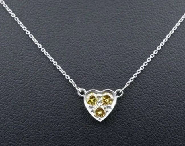 Platinum Natural Fancy Yellow Diamond Heart Pendant Necklace 18" NG957D: This eye-catching necklace features a fixed heart pendant bead-set with a trio of sparkling natural yellow diamonds inside the polished frame. A delicate cable chain with teardrop lobster clasp comple