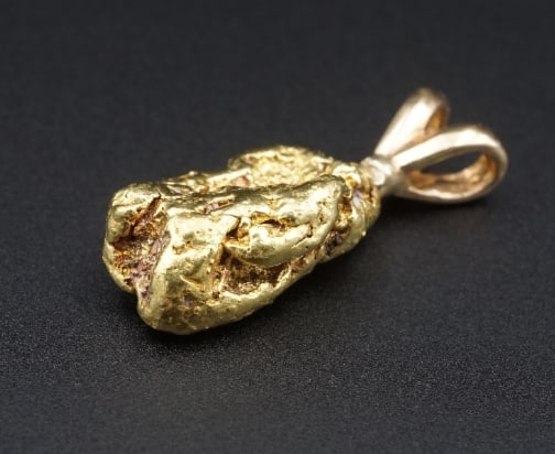 20k Yellow Gold Natural 1" Nugget 14k Pendant 9g PG2056: This handcrafted pendant features a natural gold nugget adorned with a 14k bale, creating a one-of-a-kind statement piece. The perfect accessory for a lover of natural history! Metal Type: Nugget test