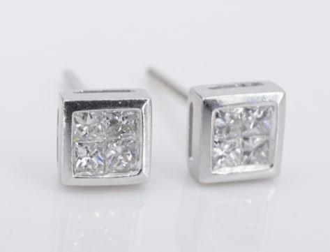 18k White Gold Diamond Stud Earrings Princess Quad Cluster Natural EG2763: These beautiful diamond stud earrings each feature an invisible-set quad of princess cut diamonds, giving the look of a quarter carat diamond in each ear! The polished white gold bezels add to the sta