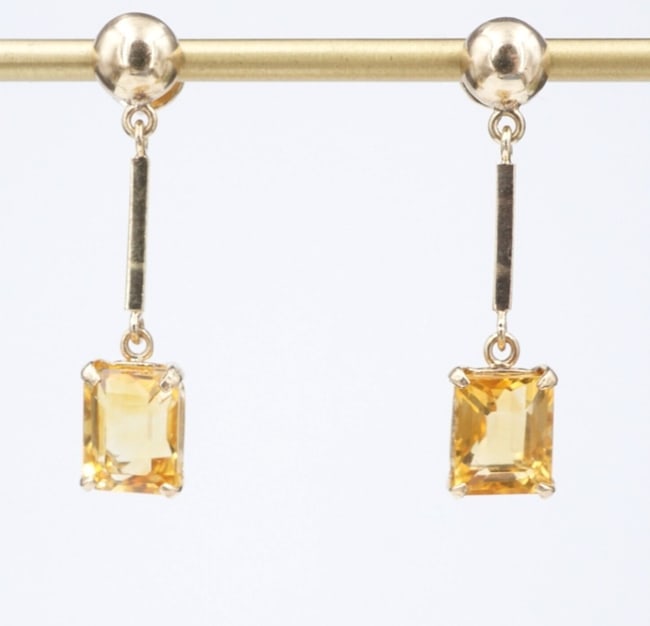 14k Yellow Gold Citrine Dangle Drop Post Earrings 1.3" Natural Classic EG2545: These lovely dangle earrings feature a gorgeous citrine prong set in an ornate basket suspended from a slim bar crafted of solid 14k yellow gold. The stud is adorned with a simple ball bead accent. Ea