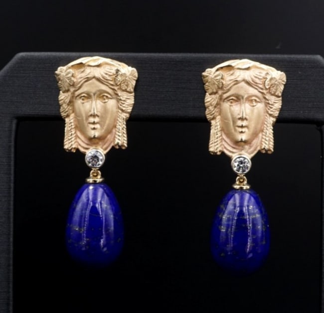 Goddess Lapis Diamond Female Repousse Drop Earrings 14k Yellow Gold 1.4" EG2664: These lovely drop dangle earrings feature an intricate repousse of a goddess crafted in rich 14k yellow gold with a large lapis lazuli gemstone dangling beneath. With a sparkling bezel set diamond in 