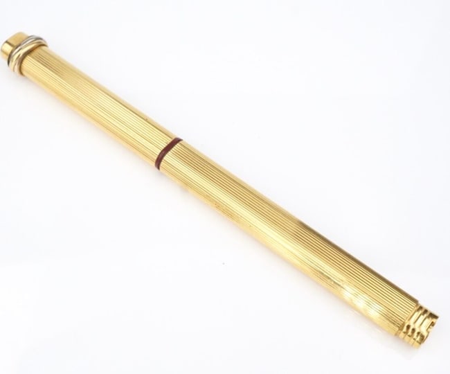 Must de Cartier Trinity Vendome Ballpoint Pen Gold Plate Pinstripe Vintage M1981: This incredible Cartier Vendome Trinity ballpoint pen is a timeless classic! The cap and barrel feature a gold pinstripe design with the iconic "trinity" rings set at the crown. With lovely maroon acc