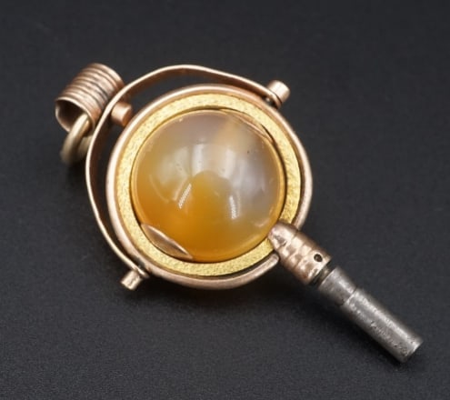 Antique Victorian 9k Gold Carnelian Watch Key Ball 1.7" PG1779: This unique pendant is an ornate pocket watch key from the 1800's. Featuring a polished carnelian orb in an articulated gold frame with delicate laurel leaf detailing and a swivel bail. A beautiful hi
