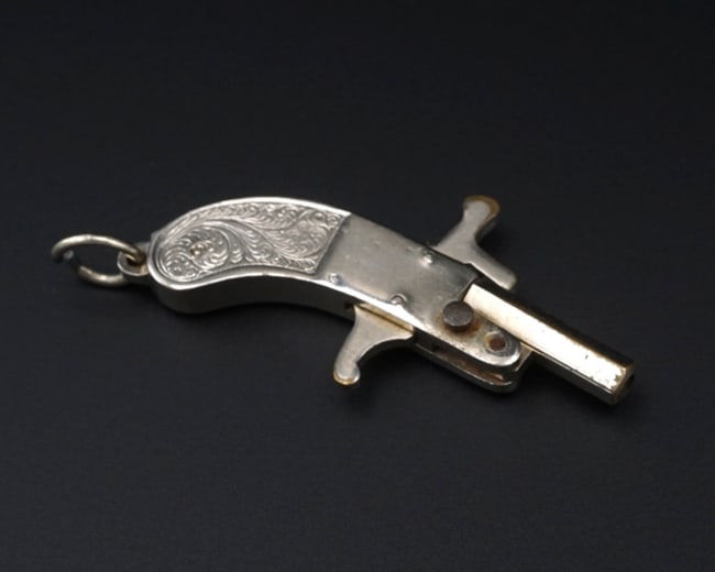 Antique Toy Pinfire Cap Gun Fob Charm Brass Mini 1.6" Germany M2025: This antique treasure features an intricate cap gun design complete with a working mechanism. Crafted in silver plated brass, this incredible design is a rare piece for any collection! Metal Type: Ste