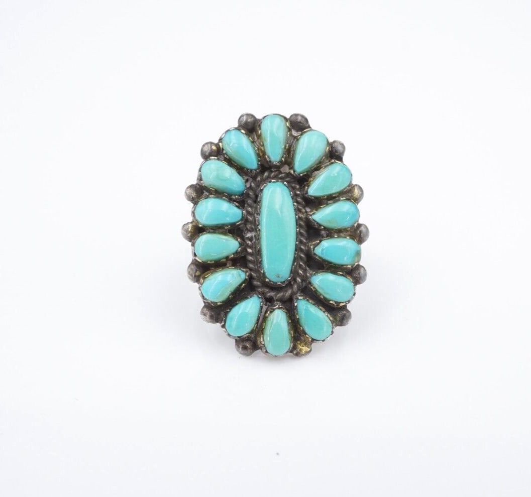Zuni Sterling Silver Turquoise Ring Size 5 Lorraine & Luwayne Waatsa: This gorgeous ring from Zuni artisans Lorraine & Luwayne Waatsa displays an ovular turquoise cabochon at center framed by a halo of additional teardrop shaped turquoise cabochons. With an intricate ro