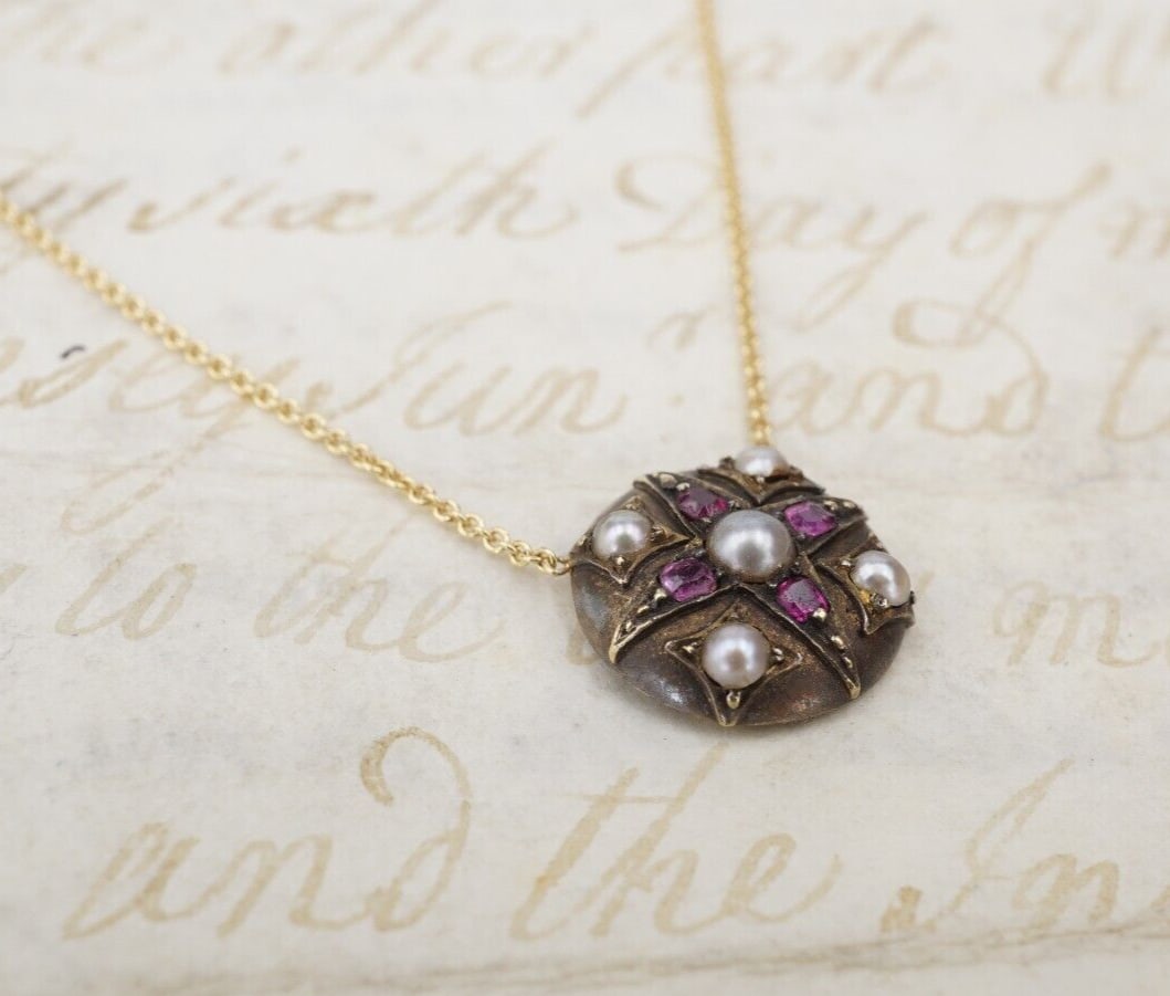 14k Yellow Gold Ruby & Pearl Fixed Antique Pendant Necklace 18": Created by our design team, this beautiful necklace features a fixed circular antique Victorian pendant set with gorgeous pearls and rubies. The pendant is suspended on a modern 14k yellow gold chain.