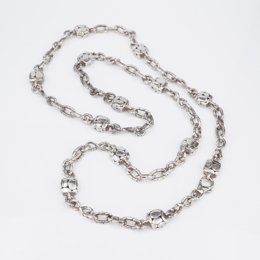 John Hardy Kali Pebble Station Necklace Sterling Silver 35": This gorgeous necklace from John Hardy features a thick pebbled cable chain with square stations etched with the iconic kali pebble design. Perfect to wear on its own or add to your favorite stack. A 