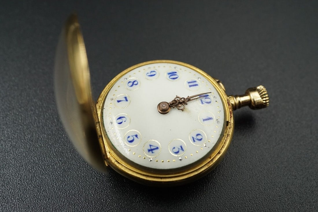 Antique Le Coultre et Cie 18k Gold Floral Case Ladies Pendant Pocket Watch: Open face watch case with ornate floral pattern. This antique watch has the bale on the bottom, and was meant to be worn as a ladies' pendant. Gorgeous bright blue numbers on ivory face complete this 