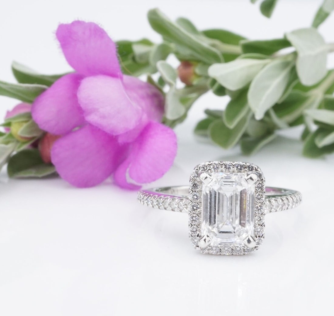 1.7ct Emerald Cut Diamond Halo Engagement Ring Size 5 Platinum D VS2 GIA: This beautiful and modern ring features an emerald-cut diamond surrounded by a bright halo of sparkling diamonds. Additional diamonds cascade down each shoulder. The slim band makes this ring an insta