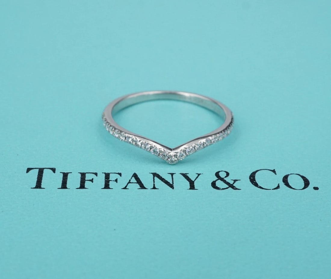 Tiffany & Co Soleste "V" Ring Diamond Platinum Size 8 Papers: This lovely Tiffany & Co. Soleste 'V" ring features a classic platinum half eternity band with a contoured shape crafted with round brilliant diamonds. A beautiful ring on its own or stacked with othe