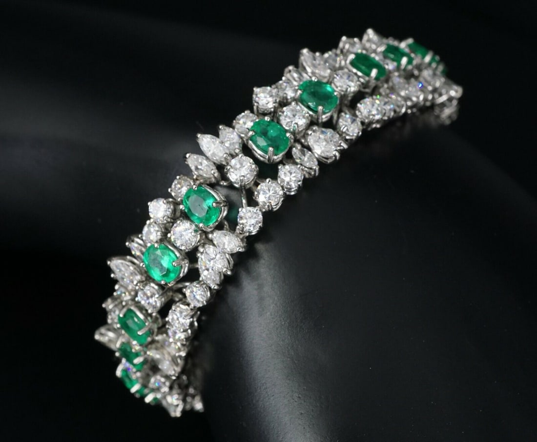 Natural Emerald and Diamond Bracelet 18k White Gold 26 carats 7": This stunning vintage bracelet features over 18 carats of marquise and round brilliant diamonds, with a center line over 8 carats of oval cut emeralds, creating a unique and brilliant design. It faste