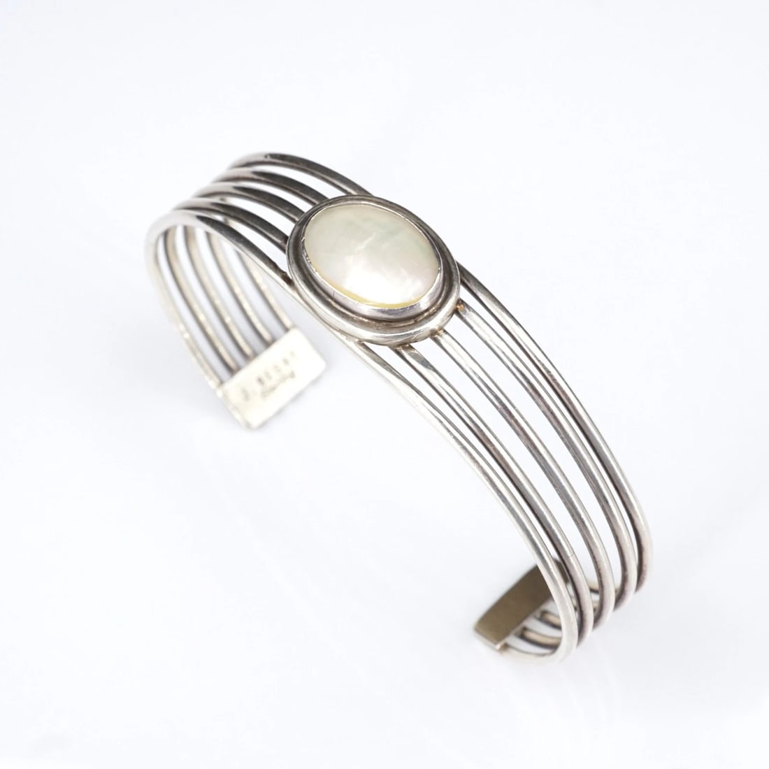 Joe Begay Cuff Bracelet Mother of Pearl Sterling Silver 7" 14mm Navajo BS3257: This stunning bracelet from Navajo designer Joe Begay features a classic 5-row cuff design crafted in solid sterling silver with an illustrious oval mother of pearl cabochon bezel set in the center. A