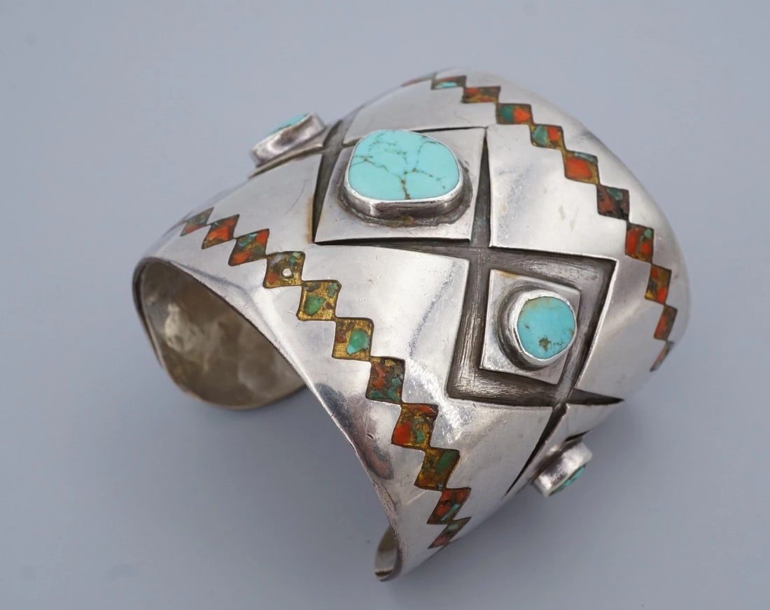 Vintage Chunky Turquoise Coral Inlay Cuff Bracelet Sterling Silver 6.75" BS2994: This striking cuff bracelet features graduated turquoise stones bezel set down the center and embellished with turquoise and coral chip inlay lining both edges of a chunky sterling silver cuff. Additi
