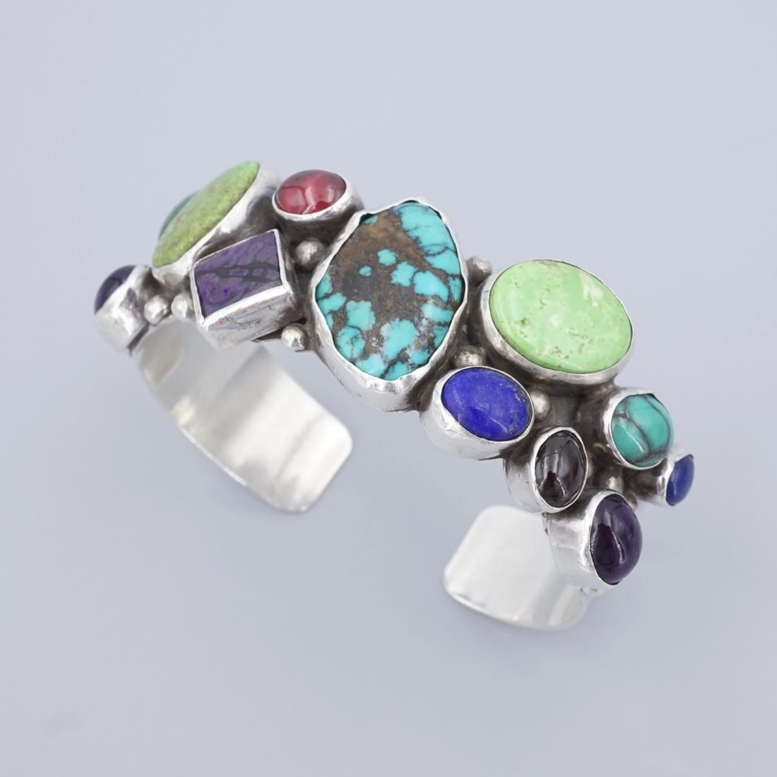 Ernest Pino Navajo Sterling Silver Turquoise Gem Cuff Bracelet Wide 6.5" BS3152: This bold design from Navajo artisan Ernest Pino features a wide sterling silver cuff embellished a cluster of bezel set turquoise and other mixed gem cabochons. Complete with bead details, this uniqu