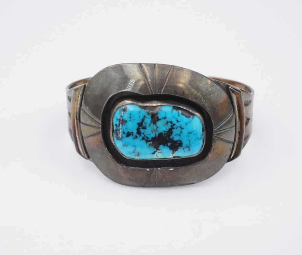 Vintage Navajo Blue Turquoise Sterling Silver Cuff Bracelet Chunky 6.25" BS3105: This lovely cuff bracelet features a beautiful blue gem turquoise slab bezel-set and framed atop a chunky sterling silver cuff with elaborate hand-stamped detailing. A stunning statement piece and a g