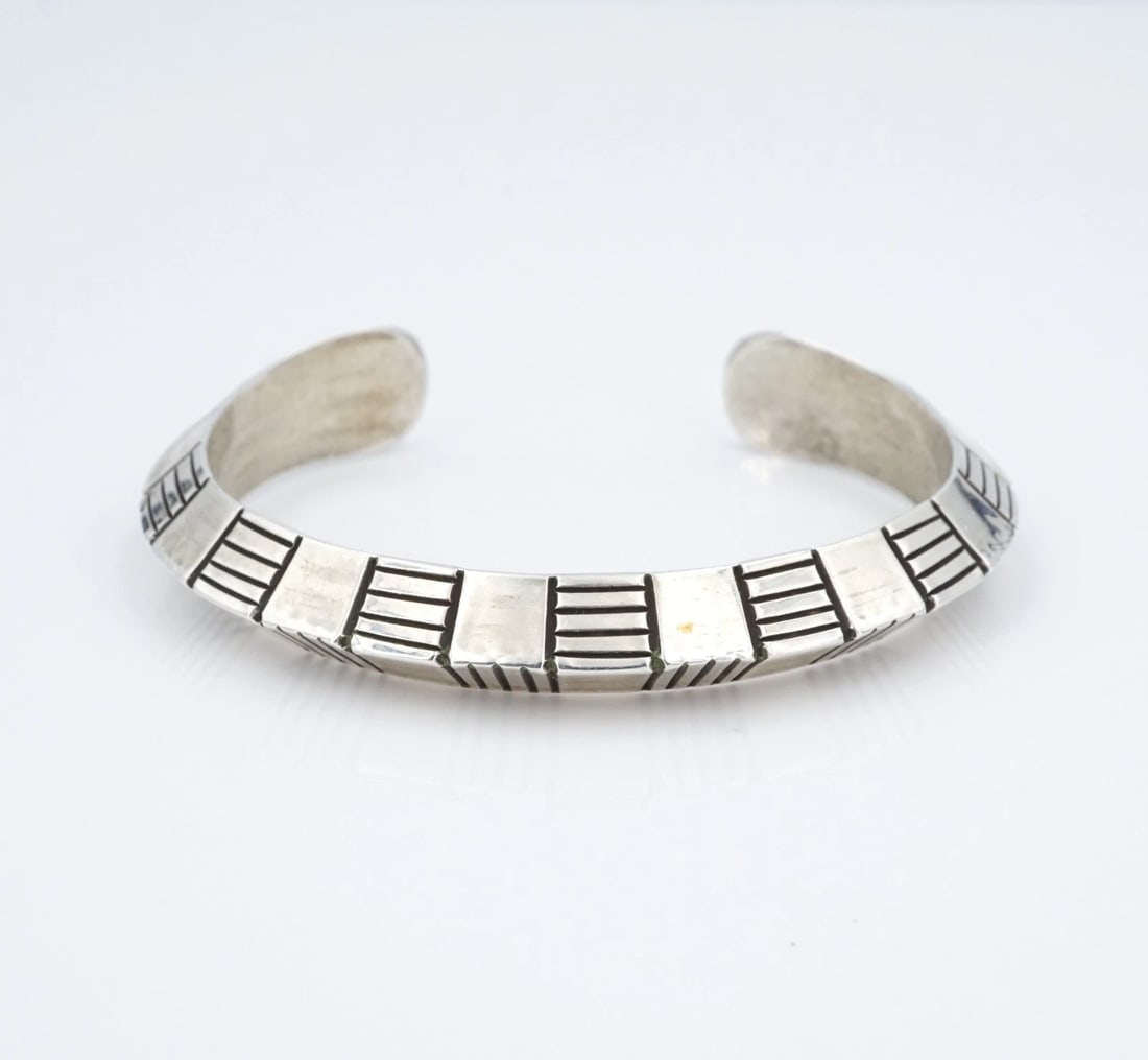 Navajo Sterling Silver Cuff Bracelet Hand Stamped Randy Secatero 6.25" BS3194: This beautiful bracelet from Navajo artisan Randy Secatero features a solid sterling silver cuff bracelet with a knife edge and stunning hand stamped designs throughout. This piece is great worn on it