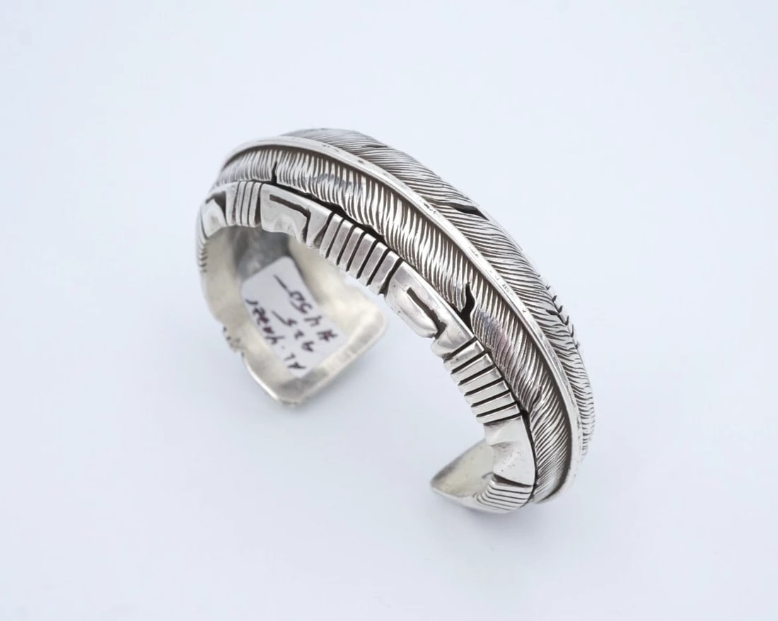 Navajo Sterling Silver Feather Cuff Bracelet Al Yazzie 6.5" Signed BS3200: This chunky Al Yazzie bracelet is crafted of solid sterling silver and features details feather curving around the face. Sleek and simple, this piece is great worn on its own or added to your favorite