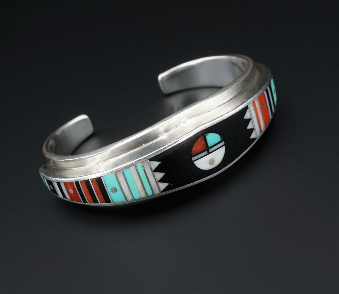 Ernest Benally Sunface Mosaic Inlay Sterling Silver Cuff Bracelet 6" BS2724: This unique vintage cuff has vivid colorful precise bars and geometric shapes of turquoise, coral, onyx, and mother of pearl inlaid into the entire face of this tapered cuff bracelet. A beautiful pop 