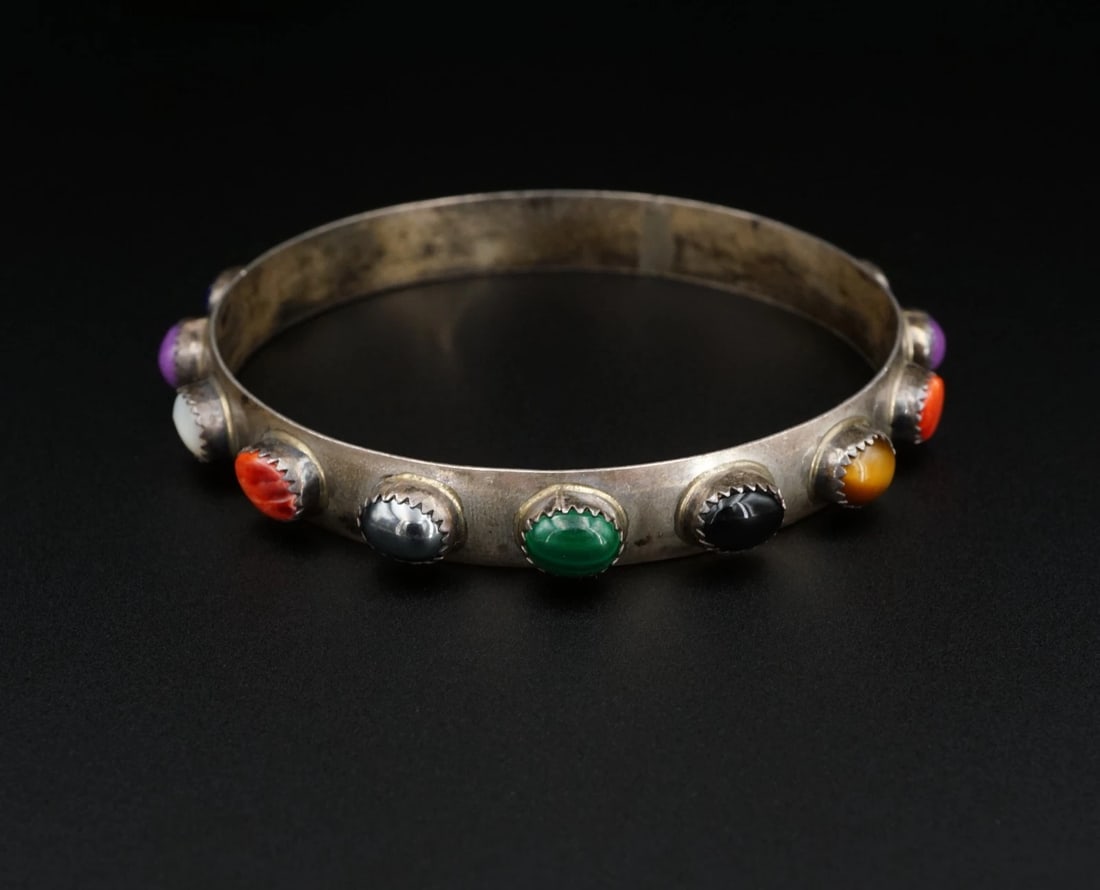 Lenora Begay Multi-Gemstone Cuff Bracelet Sterling Silver 8" Navajo BS3218: This impressive cuff from Navajo designer Lenora Begay features a classic sterling silver bangle embellished with a rainbow of gemstones such as turquoise, hematite, sugilite, malachite, mother of pea
