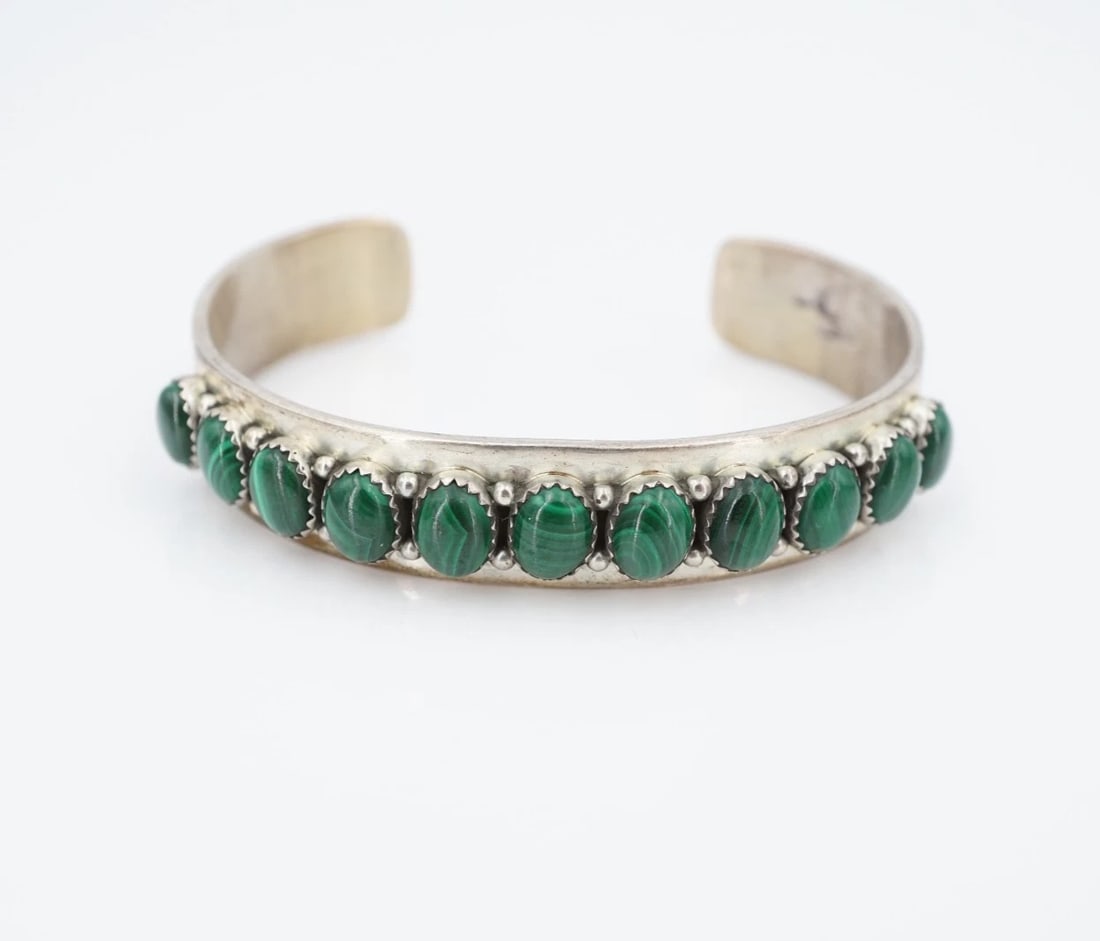 J. Begay Malachite Cuff Bracelet Sterling Silver 6.5" 13mm Navajo BS3267: This stunning bracelet from Navajo designer Joe Begay features a slim sterling silver cuff design embellished with a row of natural, bezel-set malachite cabochons. Complete with gorgeous hand stamped 