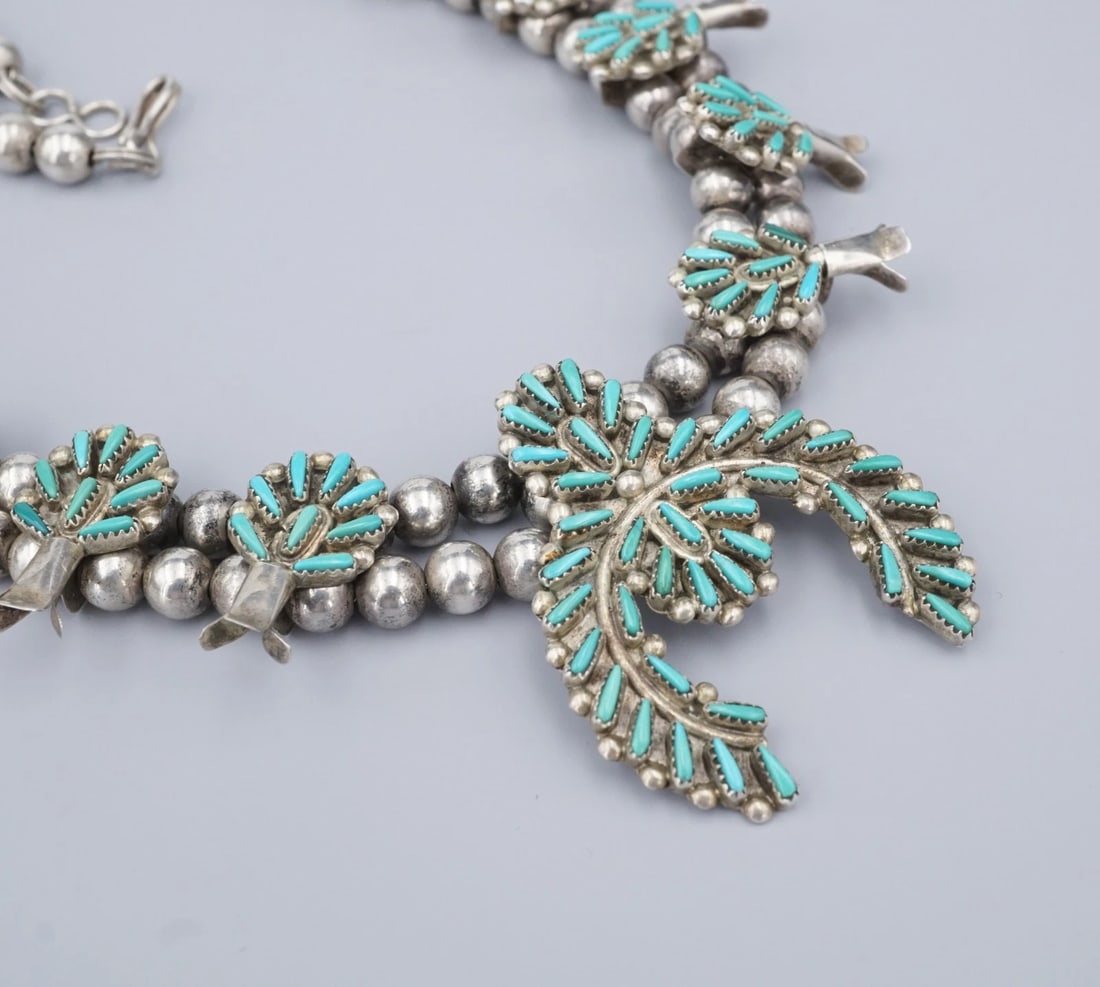 Petite Zuni Turquoise Squash Blossom Necklace Sterling Silver 21" Acque NS2312: This beautiful Zuni necklace, from Gloria Acque, features a gorgeous squash blossom design adorned with petite point turquoise cabochons bezel set in sterling silver frames. A great addition for any c