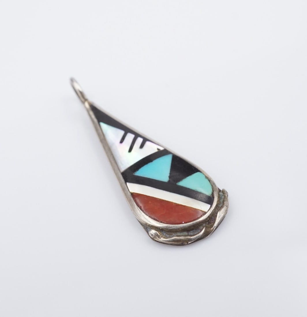 Zuni Sterling Silver MOP Turquoise Onyx Inlay Pendant Charles Booqua PS2169: This beautiful teardrop pendant from Zuni artisans Charles and Marlene Booqua features inlaid mother of pearl, black onyx, turquoise, and coral set in sterling silver. A fun accessory for any Native A