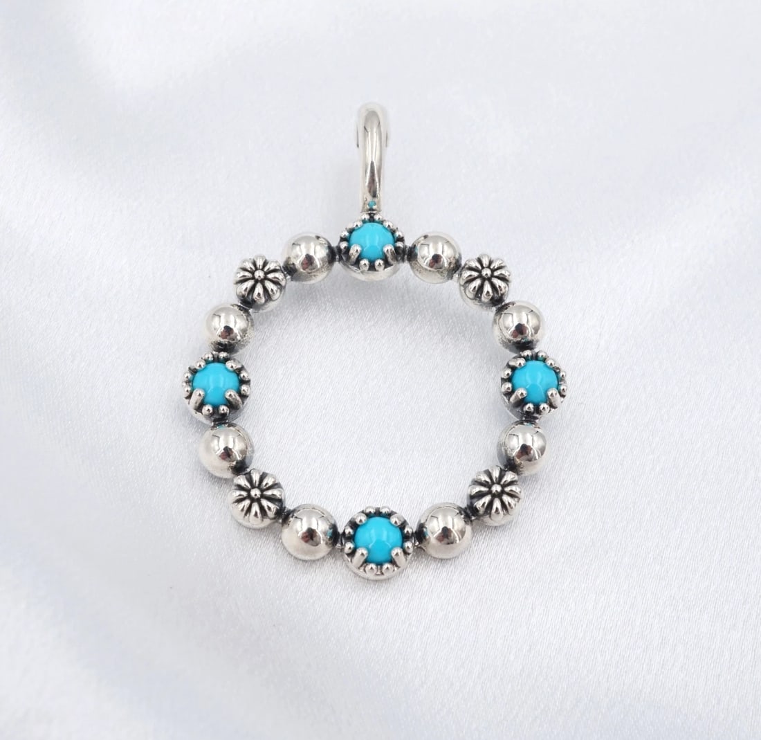 American West Sleeping Beauty Turquoise Circle Pendant Sterling Silver PS2338: This beautiful American West pendant enhancer features blue sleeping beauty turquoise cabochons with floral and smooth beads alternating in a circular wreath design, crafted in sterling silver. This g