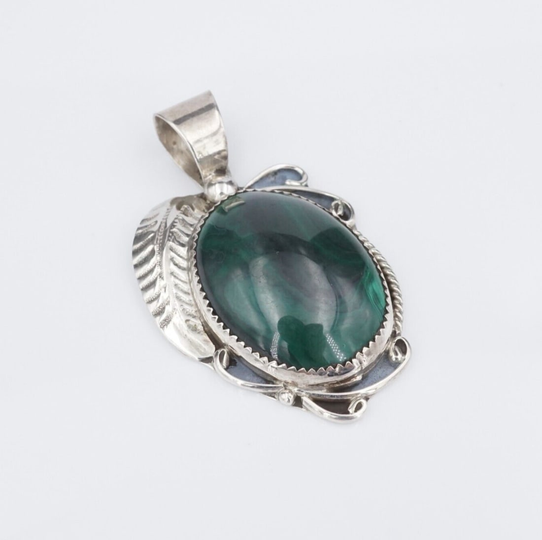 Navajo Sterling Silver Malachite Pendant Cabochon 2" Calvin Tom Large 20g PS2176: This Navajo pendant features a beautiful oval cabochon of malachite with gorgeous whorls and swirls of green. The large tapered bale gives this piece a bold look and accommodates a variety of chains, 
