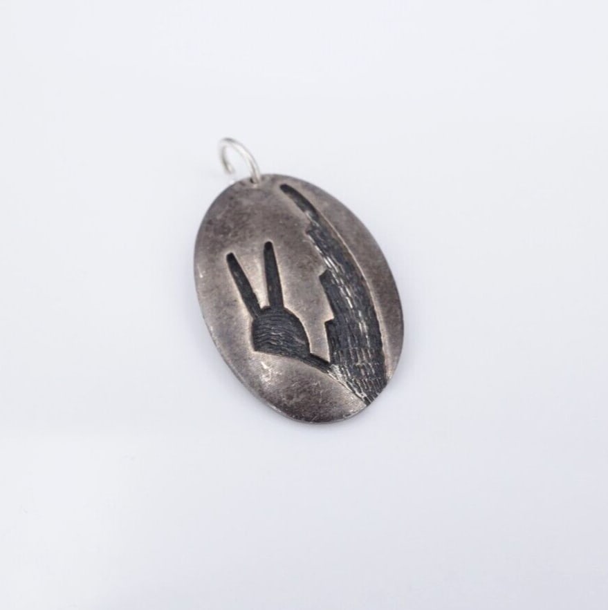 Hopi Native American Sterling Silver Pendant Stephen Hyson Naseyoma 0.85" PS2149: This Hopi pendant by artisan Stephen Hyson Naseyoma, features an oval construction with a hand stamped, textured design. The pendant is crafted in sterling silver. Add this to any Native American coll