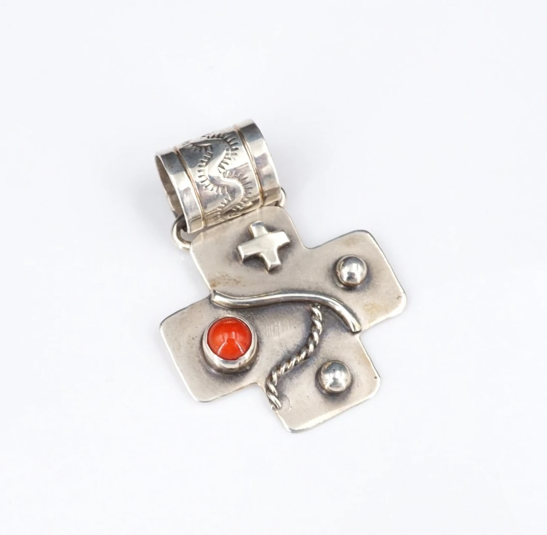 Navajo Red Coral Cross Pendant Sterling Silver 1.5" Bead Nakai PS2340: This beautiful Navajo pendant centers on a red coral cabochon bezel set atop a solid sterling silver cross pendant with a cross, beads and rope designs. Complete with hand stamped designs on the bale,