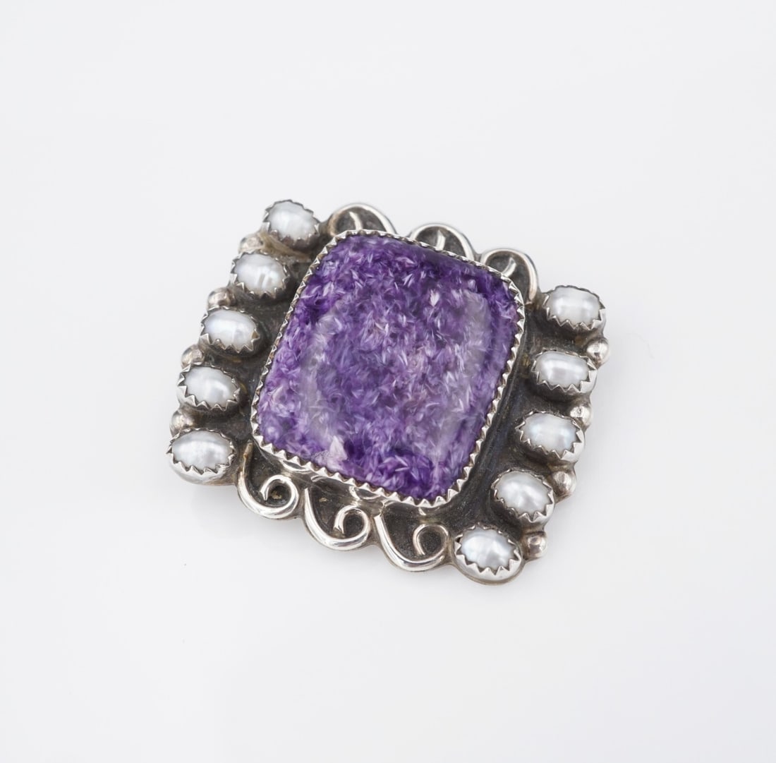 Navajo Pendant Brooch Sterling Silver Purple Chaorite Pearl Emma Lincoln PS2224: This pendant from Navajo Silversmith Emma Lincoln features a deep purple charoite cabochon set in a sawtooth bezel with pearl and swirled accents. All crafted from solid sterling silver. This piece wo