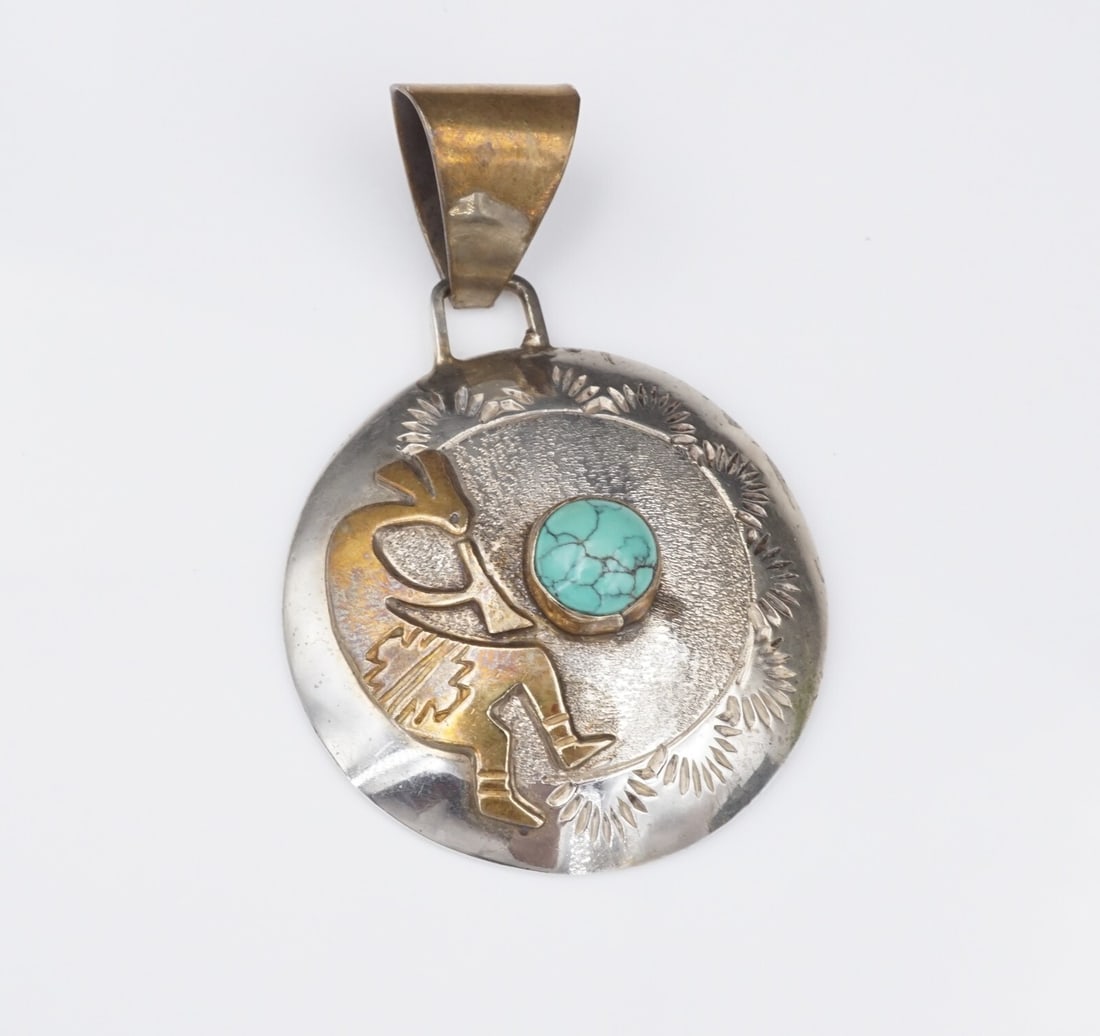 Navajo Sterling Silver Turquoise Pendant Kokopelli 2.2" Robert Johnson PS2201: This stunning sterling silver pendant from Navajo artisan Robert Johnson features a classic disc shape with an intricate gold tone Kokopelli design and a bezel set turquoise cabochon in the center. Th