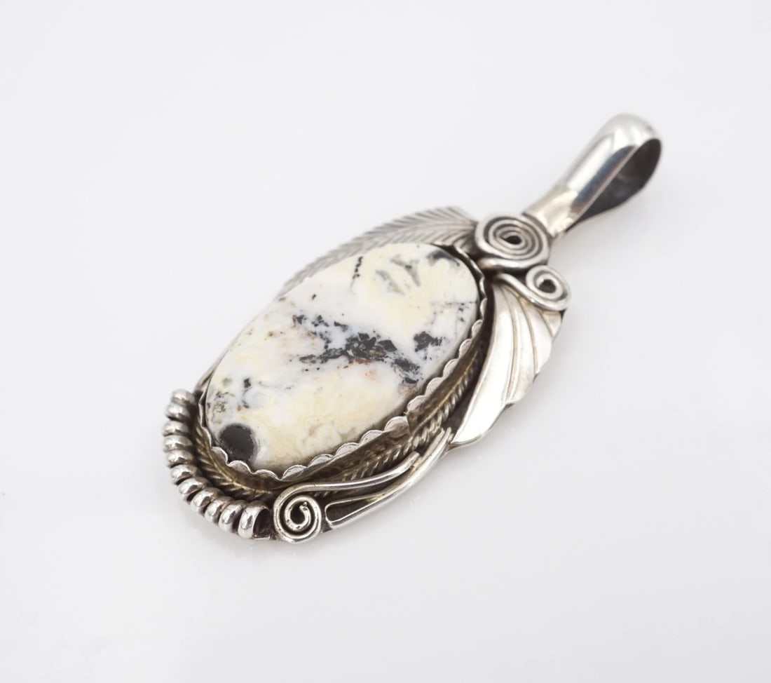 Justin Morris White Buffalo Turquoise Pendant Sterling Silver 2.2" Navajo PS2371: This beautiful pendant from Navajo artisan Justin Morris features an elongated white buffalo turquoise cabochon set in a sawtooth bezel with a large bale, perfect for pairing with different chains. Co