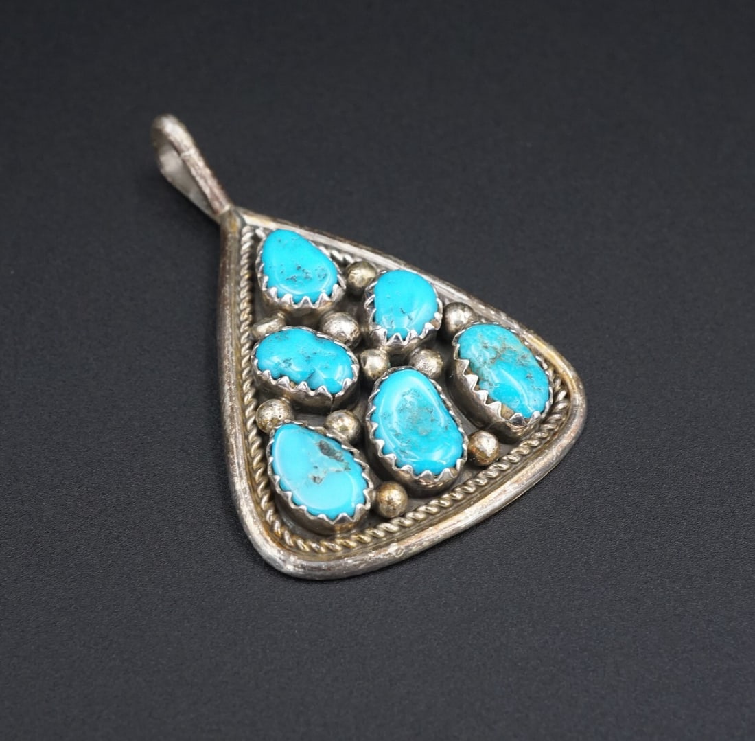Navajo Turquoise Pendant Irene Chiquito Sterling Silver 1.5" Triangle PS1883: This Navajo pendant features bezel set turquoise cabochons set among silver beads, within a triangular rope from. All created in solid sterling silver. A great look that is sure to be an everyday piec
