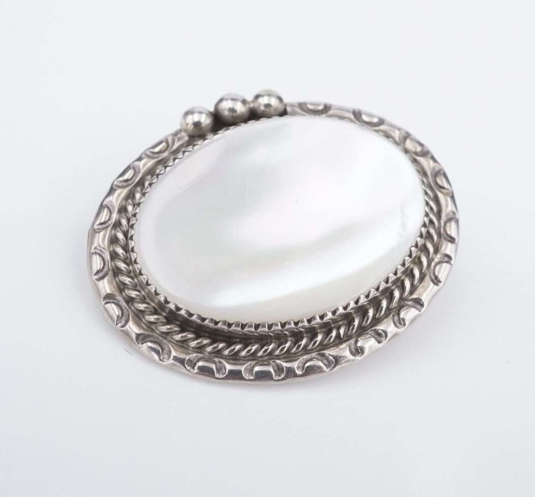 Navajo Pendant Brooch Sterling Silver Mother of Pearl MOP 1.5" Signed AMB PS2145: This large pendant features a silky mother of pearl cabochon bezel set in a frame of sterling silver. This piece would make a great gift for anyone who loves statement or Native American jewelry. Can 