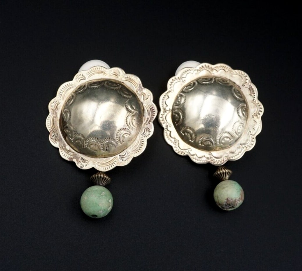 Joan Slifka Sterling Silver Concho Turquoise Dangle Clip Earrings 2.2" ES2469: These statement earrings feature hand stamped sterling silver conchos with turquoise bead dangles. The bright and bold color palette makes these earrings truly eye-catching! Metal Type: Sterling Silve