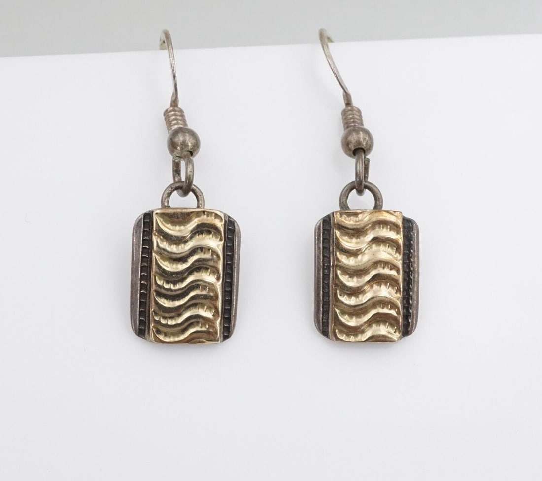 Hopi Dangle Earrings Sterling Silver 14k Gold Overlay 1.25" Coochwytewa ES2364: These lovely Hopi earrings are crafted of solid sterling silver with a 14k yellow gold overlay displaying a wave design. The earrings fasten securely with sterling hooks, providing movement when worn.