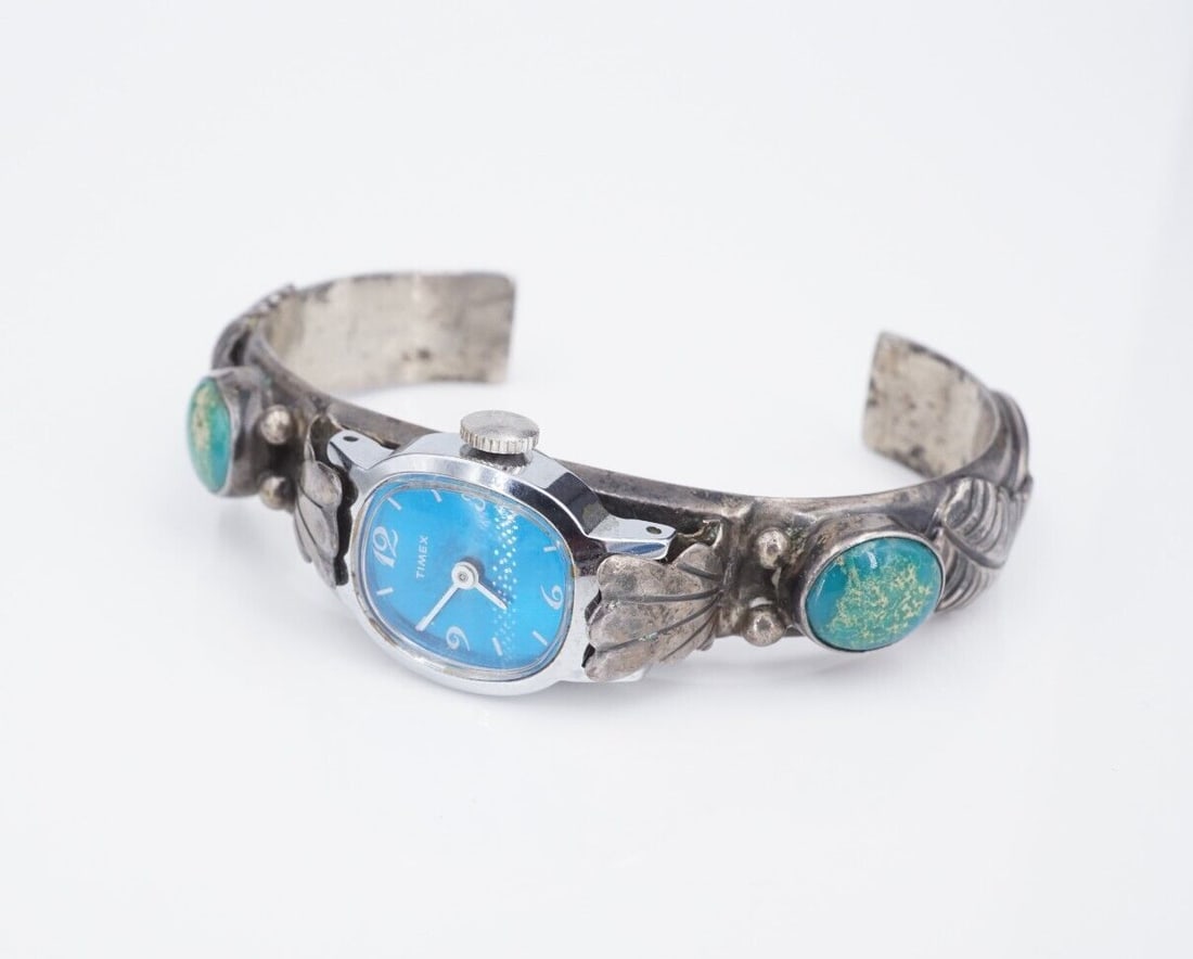 Navajo Turquoise Watch Cuff Sterling Silver Turquoise Signed K.M. 7" W868: This Navajo artisan watch cuff features beautiful oval turquoise cabochons bezel set on each arm. Feather and ball accent details complete the look. Crafted of solid sterling silver, this watch is gre