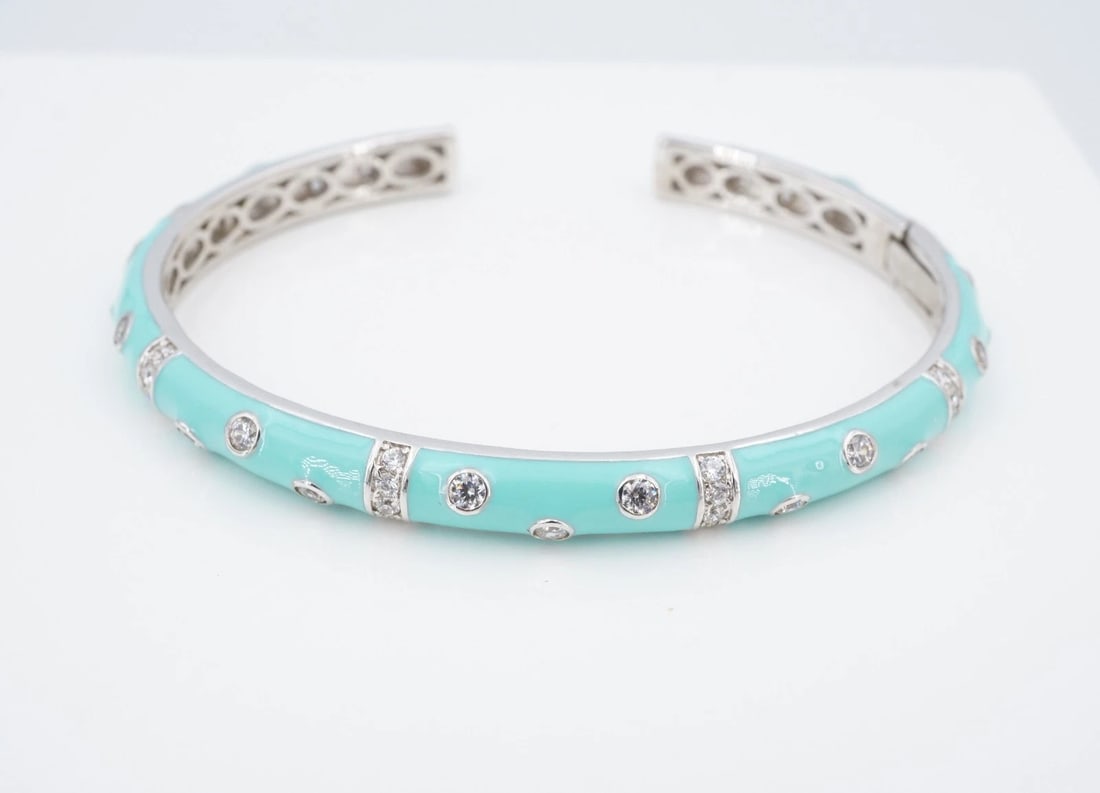 Hidalgo Teal Enamel CZ Station Cuff Bracelet Hinged Sterling Silver 8" BS3344: This Hidalgo bracelet features a slim, sterling silver cuff embellished with teal enamel and stations of sparkling CZ accents. Metal Type: Sterling Silver Notable Marks: China H CZ 925 Measurements: 8