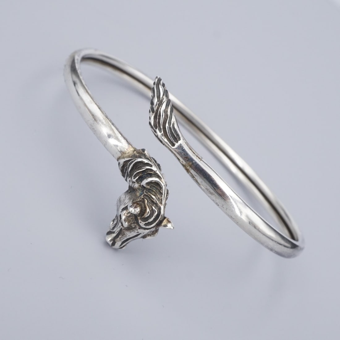 Greek Jewelry Shop Horse Torc Bangle Bracelet Sterling Silver 6.5" BS3094: This classic torc bracelet from the Greek Jewelry Shop features a polished sterling silver bangle with the head of a horse on one end, and the tail on the other. Metal Type: Sterling Silver Notable Ma