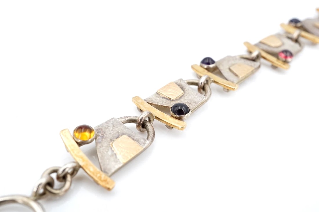 Idelle Hammond-Sass Artisan 14k Sterling Silver Panel Bracelet Mixed Gem BS3159: This handsome panel link bracelet features solid sterling silver curb link sections spaced by curved bars capped with 14k gold. The bracelet fastens with a lobster clasp. Metal Type: Sterling Silver a