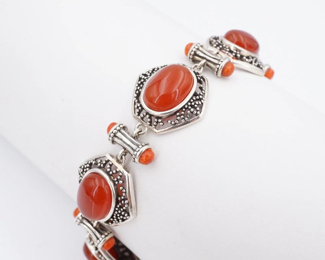 Jean Lin Carnelian Coral Toggle Bracelet Sterling Silver 7.75" Estate BS3297: This vintage bracelet from designer Jean Lin features large carnelian cabochons bezel set atop openwork, hexagon links with ornate bead accents. Each link is separated by metal bars embellished with q
