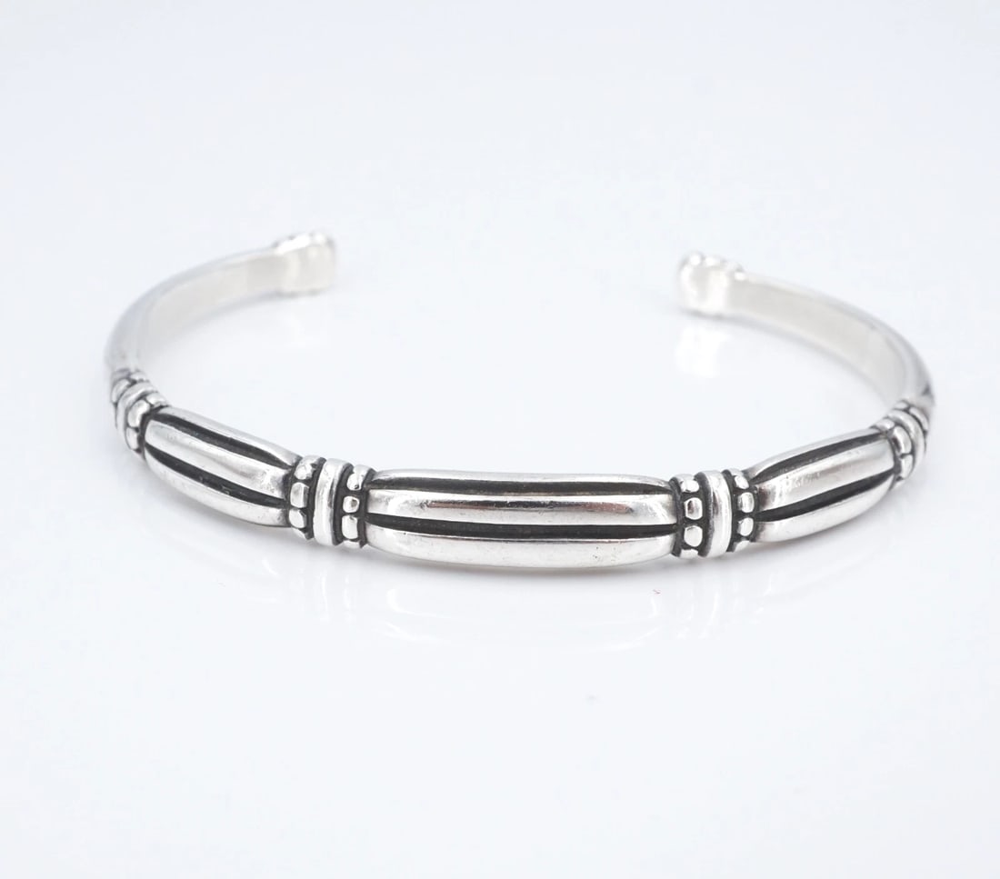 James Avery Thatch Cuff Bracelet Sterling Silver 6.5" 7.1mm Retired BS3246: This retired James Avery "Thatch" cuff bracelet features a grooved design with bead accents, all crafted in solid sterling silver. Metal Type: Sterling Silver Notable Marks: JA Hallmark STER Measureme