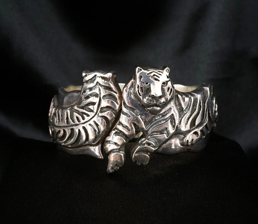 Emilia Castillo Tiger Bangle Bracelet Hinged Sterling Silver 7.5" Mexico BS3260: This hinged bracelet from designer Emilia Castillo features a wide sterling silver bangle embellished with two intricate tiger motifs resting on the face. Metal Type: Sterling Silver Notable Marks: 92