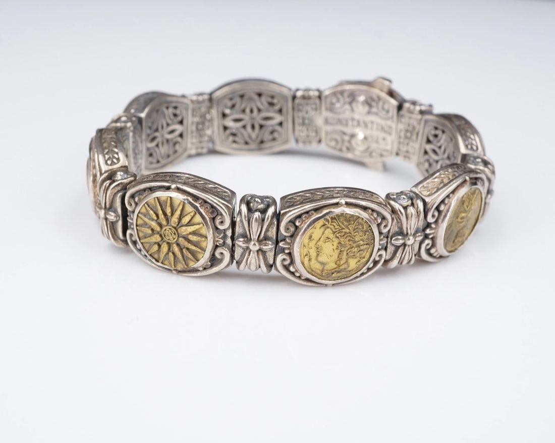 Konstantino Bronze Coin Station Bracelet Sterling Silver Greek 6.5" BS3238: This treasure bracelet features ancient Greek inspired bronze coins, each mounted in sterling silver frames with swirl and bead accents. Floral cutout detail can be seen on the underside. This piece h