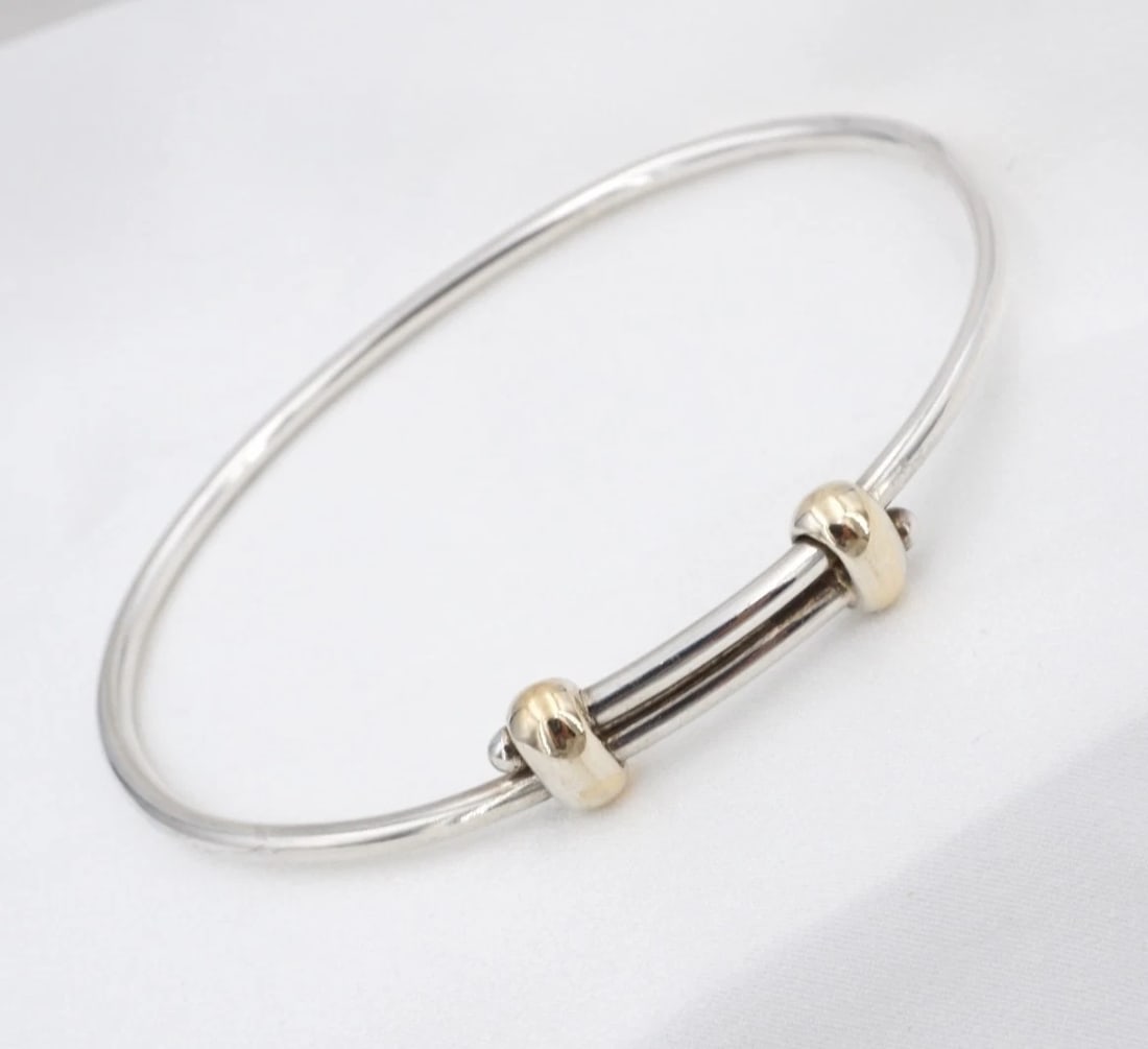 James Avery Expandable Slider Bracelet Sterling Silver 14k 7.5" Retired BS3364: This retired James Avery bracelet features an adjustable sterling silver slider bangle embellished with 14k yellow gold stations. This versatile piece can be worn on its own or added. Metal Type: Ster