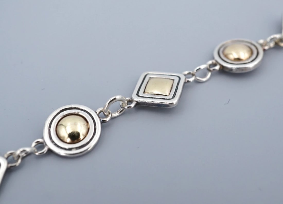 James Avery Geometric Shapes Bracelet 14k Gold Sterling Silver 8" Retired BS3214: This rare and retired James Avery bracelet is crafted of alternating round and square links embellished with a dome of 14k yellow gold in the center of each link. Crafted in solid sterling silver. Met